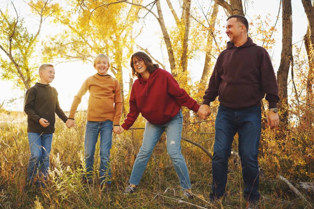 Castle Rock Family Photography Session with family jumping up and smiling