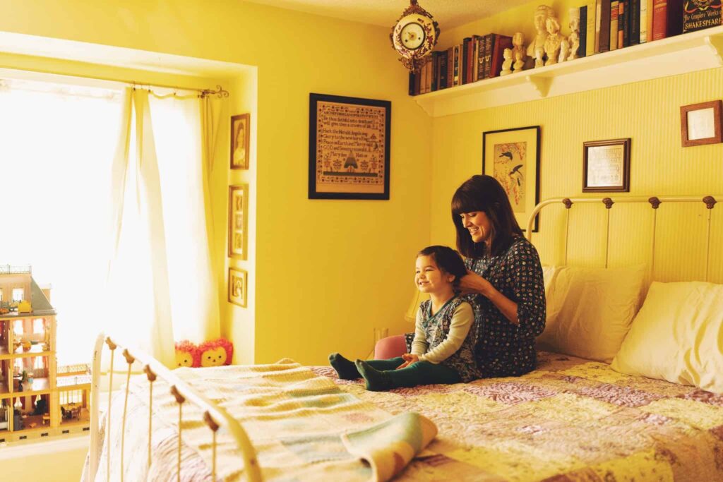 Photograph of a Denver mother and daughter getting ready for family photos. 